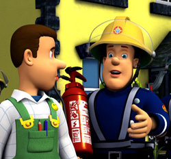 A man in green overalls talks to a smiling firefighter wearing a yellow helmet and blue uniform.