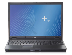 An open black HP laptop displaying a blue patterned wallpaper with the HP logo.