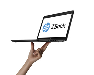 A person's hand holding an open HP ZBook laptop against a white background.