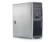 A silver and black HP desktop computer tower standing on a white surface.