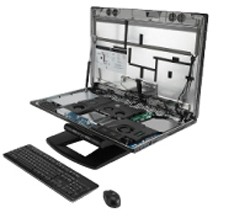 An open computer tower revealing internal hardware, accompanied by a black keyboard and mouse.
