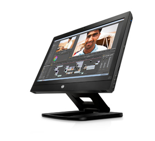 A black widescreen computer monitor angled to the right, displaying a video editing interface with a man's face.