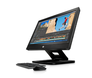 A black computer monitor showing video editing software, a keyboard, and a mouse on a white background.