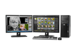 Two computer monitors, a black desktop tower, a keyboard, and a mouse on a white background.