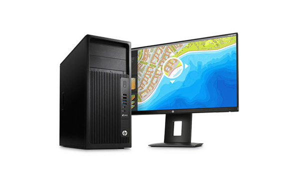 Black HP computer tower next to a wide computer monitor displaying a coastal map.