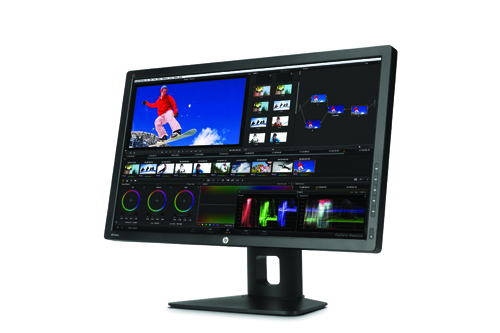 A wide computer monitor displaying a video editing interface with various timelines, clips, and color grading tools.