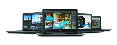 Four black laptops arranged in a row, displaying video editing, 3D modeling, and graphic software.