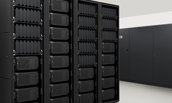 Multiple black server racks filled with hardware components in a clean, modern data center environment.
