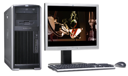 A silver and black desktop computer tower next to a monitor, keyboard, and mouse on a white background.