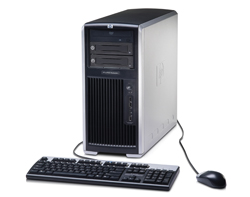 Silver and black desktop computer tower, black keyboard, and black computer mouse on a white background.