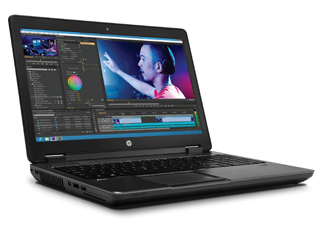 A dark grey laptop open on a white background, showing a video editing interface on the screen.