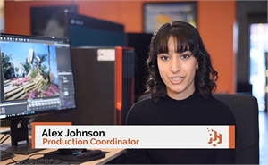 Alex Johnson, Production Coordinator, sits in front of a computer monitor in an office.