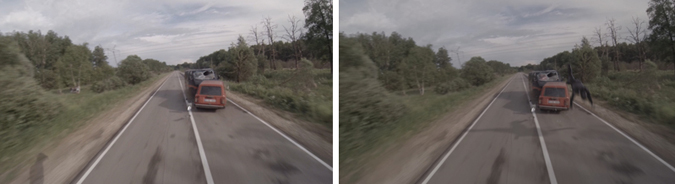 A red van and a dark car crashed on a two-lane road lined with trees.