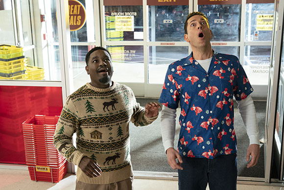 Two men with shocked facial expressions standing in a doorway.