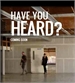 Text overlay reading 'HAVE YOU HEARD? COMING SOON' over a blurry indoor scene with two people walking.