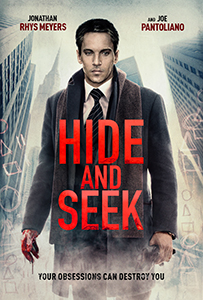A man in a dark coat and tie stands before city skyscrapers; the title 'HIDE AND SEEK' is in large red letters.