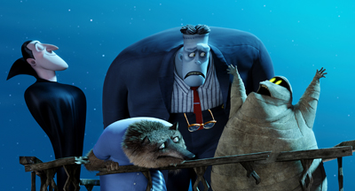 Four animated monsters, including a vampire and a mummy, stand together against a blue background.