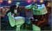 Two pale, stylized figures sit near a large, rounded object under colorful hanging lights.