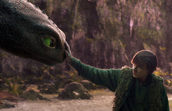 A person in a green tunic reaches out to touch the snout of a large, green-eyed dinosaur in a forest.
