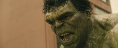 Close-up of a large, muscular green-skinned creature with a furrowed brow and bared teeth.