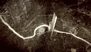 Sepia aerial view of a winding river cutting through a dark, textured landscape with a tall, thin structure.