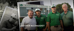 Four men posing in front of a Marshall University scoreboard, some wearing green shirts and white caps.