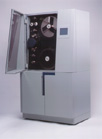 A large, light gray vintage reel-to-reel tape recorder with its glass door open, revealing two large tape reels.