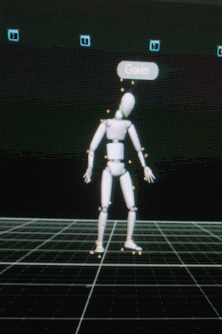 A white 3D humanoid digital model with orange joint markers standing on a dark grid.
