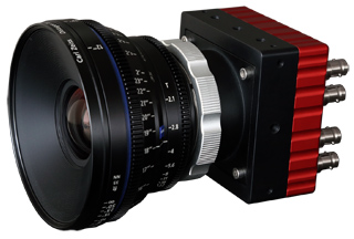 A black and red industrial camera equipped with a large, black professional lens.