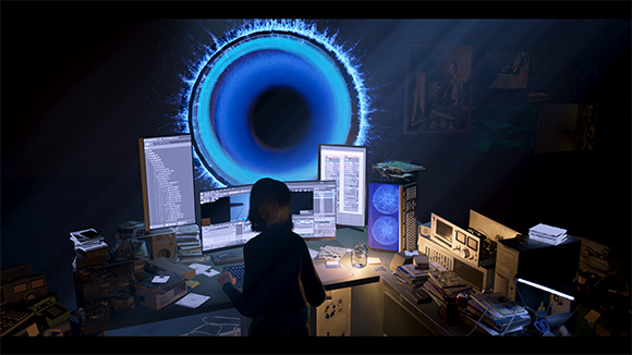 A person sits at a cluttered desk with multiple monitors, facing a large, glowing blue ring on a dark wall.
