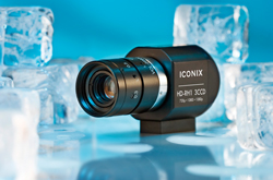 A black Iconix HD-RMI 3CCD camera sits among clear ice cubes on a reflective blue surface.
