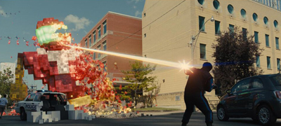 A large red pixelated figure shoots a beam of light at a person standing near a car on a city street.