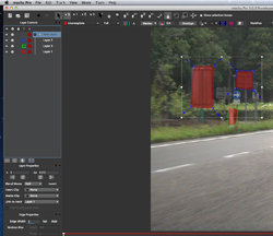 Interface of video editing software displaying a road scene with red rectangular overlays and transformation handles.