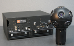 A black rectangular control box with various ports next to a spherical black camera with multiple lenses.