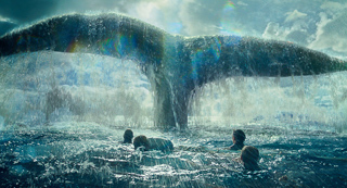A massive whale tail rises from the ocean waves near people swimming in the water.