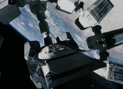 A modular space station structure viewed from above against the backdrop of Earth and space.