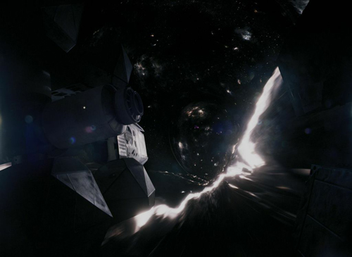 A dark spacecraft moves through space toward a glowing, swirling black hole amidst distant stars.