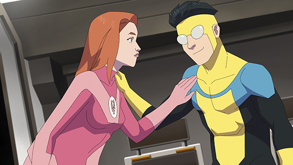 Animated woman with red hair in pink clothing touches the shoulder of a man in a yellow and blue superhero suit.