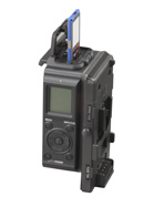 A black handheld electronic device with a small LCD screen and a blue card inserted into a slot at the top.