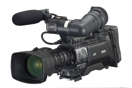 A black JVC professional video camera with a large lens, microphone, and viewfinder against a white background.