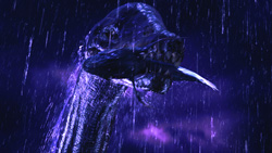 A large, dark, textured creature with a long neck and wide mouth under heavy rain at night.