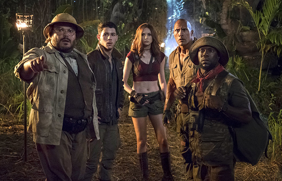 Five diverse adventurers in safari gear stand in a dense, dark jungle looking forward.