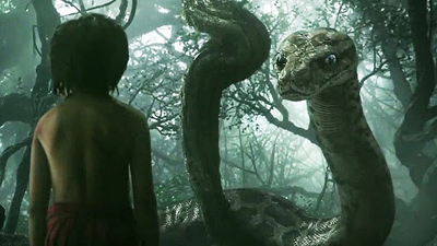 A young boy stands in a misty jungle facing a large, upright snake.