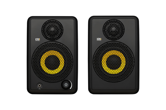 Two black KRK studio monitors with large yellow cone drivers on a white background.