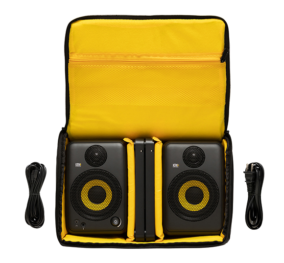 Two black speakers nestled inside a black carrying case with a bright yellow interior.