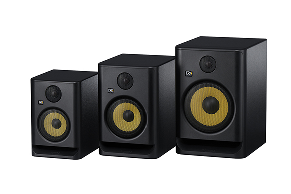 Three black KRK studio monitors arranged from smallest to largest on a white background.