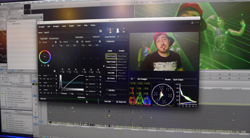 Computer screen showing video editing software with color grading tools and a preview window with a man wearing a red hat.