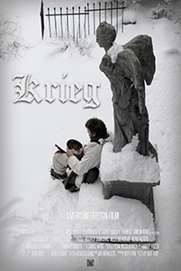 A person sits in the snow next to a large angel statue in a wintry landscape.