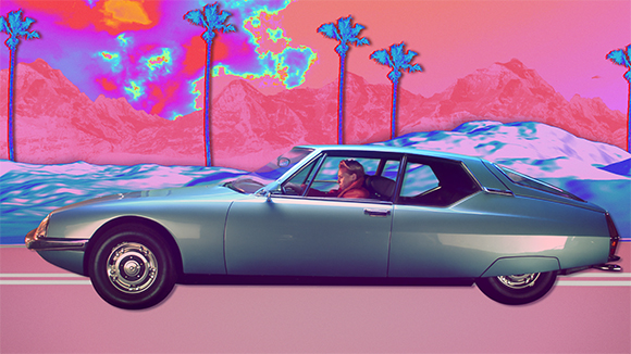 A light blue vintage car drives through a surreal landscape of pink mountains, palm trees, and colorful clouds.