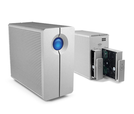 Two silver rectangular server storage units on a white background, one showing an open hard drive bay.